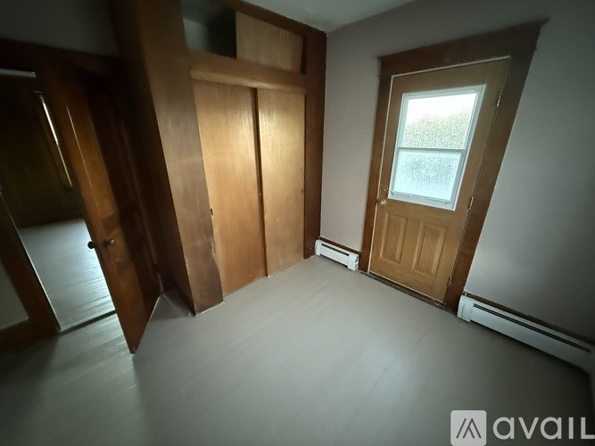 A room with a window and a door.