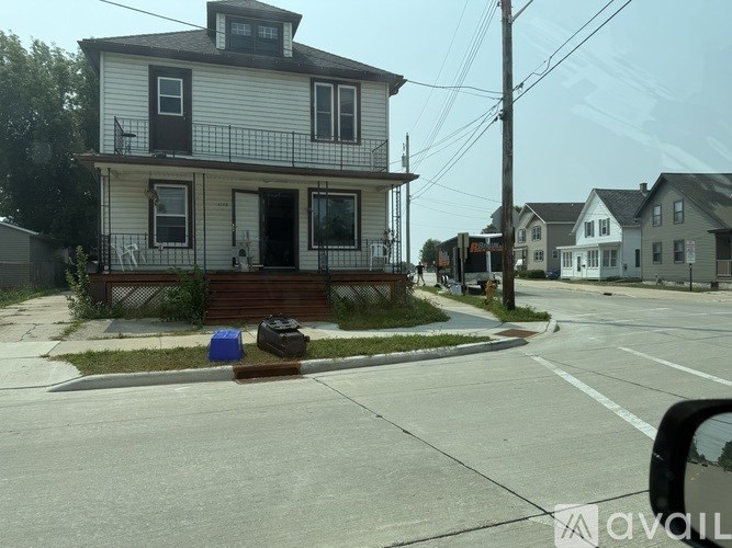 A two-story house with a balcony on the second floor.