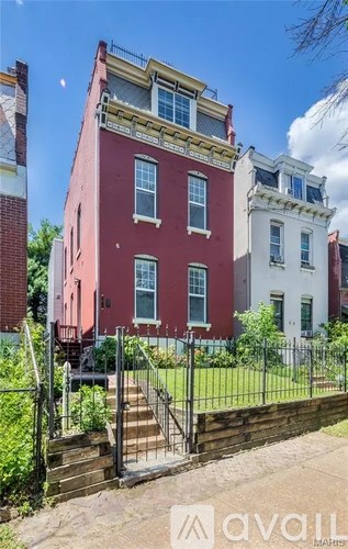 A red building with a white building in the background.