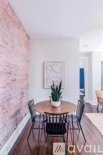A dining room with a round table and chairs.