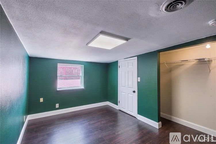 A room with a green wall and a white door.