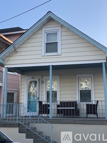 A house with a blue door and a window with a white frame.