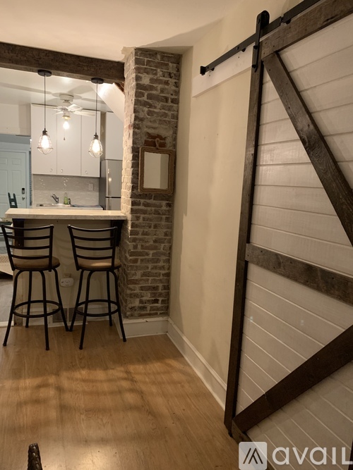 A kitchen with a bar area and a sliding door.