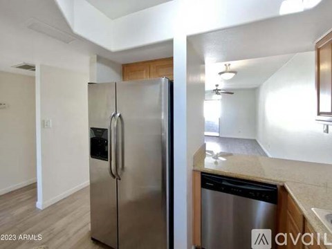 A kitchen with a stainless steel refrigerator and a stainless steel dishwasher.