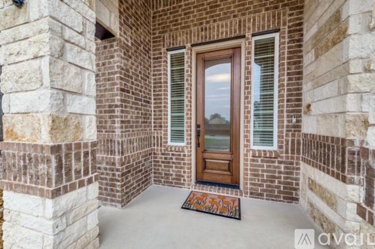 A house entrance with a brown door and window.