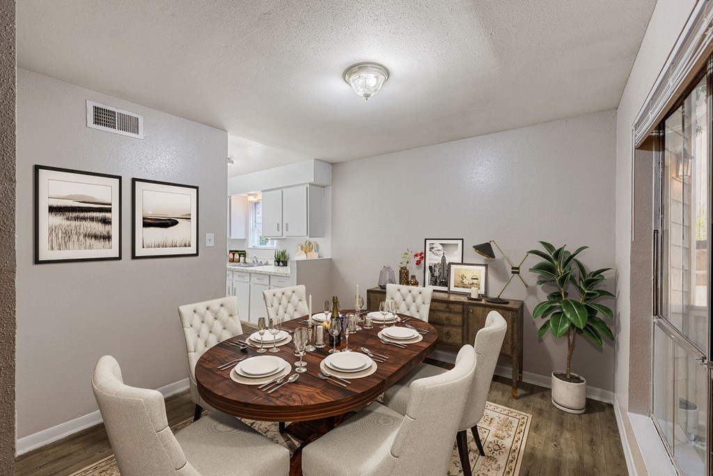 A dining room with a round table and chairs.