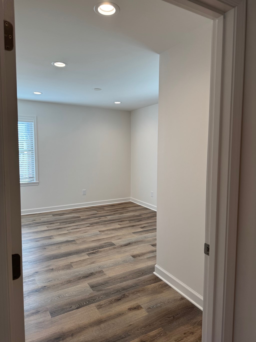 A room with a wooden floor and white walls.