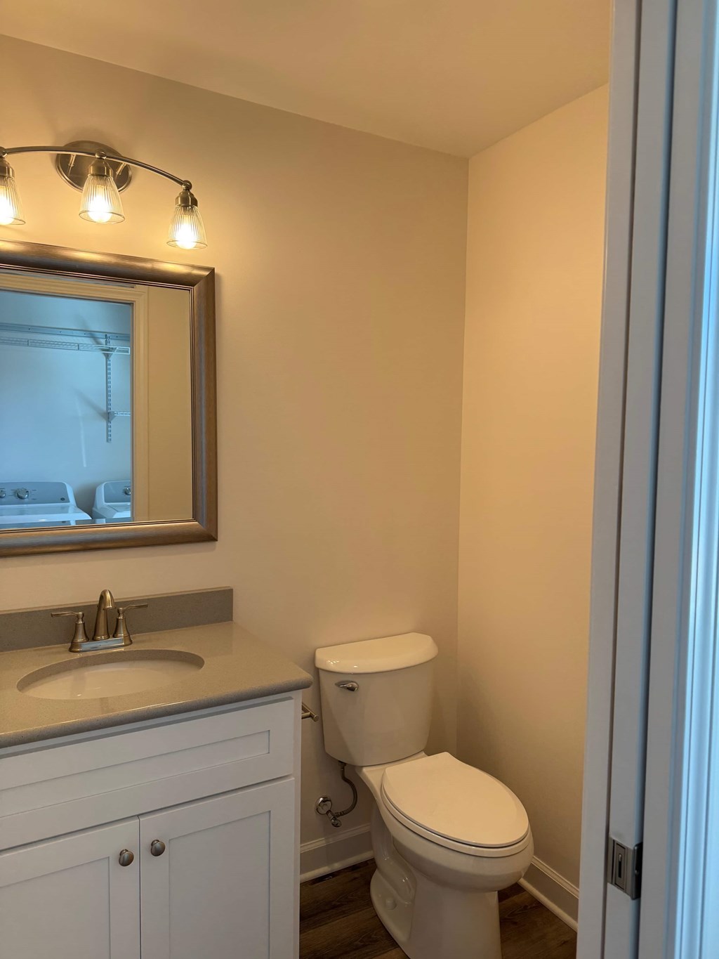 A white toilet sits next to a sink in a bathroom.