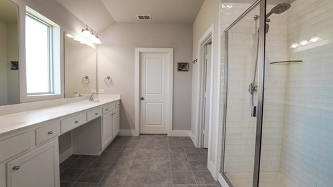 A white bathroom with a walk in shower.