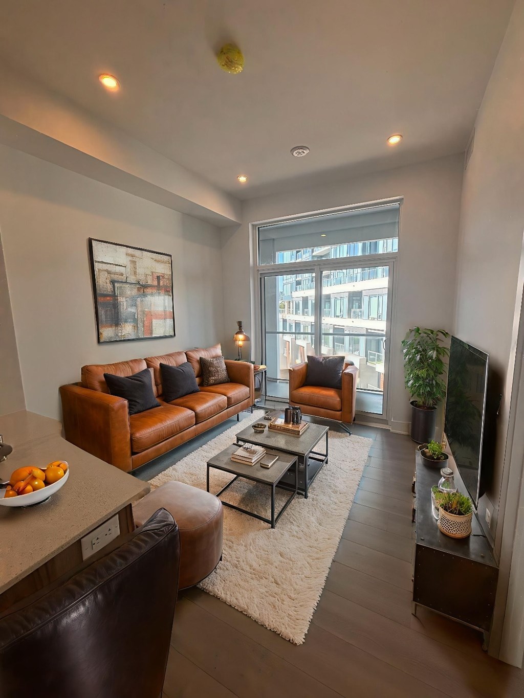 A living room with a brown couch and a coffee table.