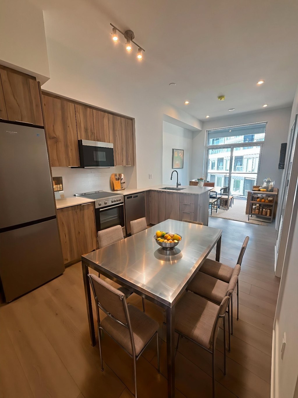 A modern kitchen with a dining table and chairs.