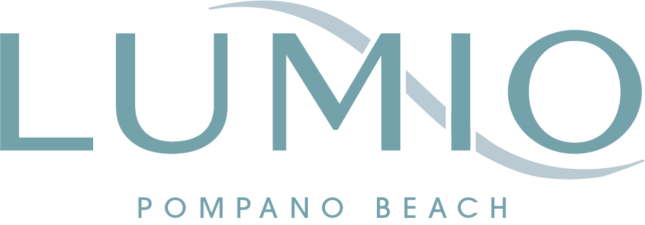 A green sign with the word "LUMINO" in large letters and "POMPANO BEACH" in smaller letters below it.