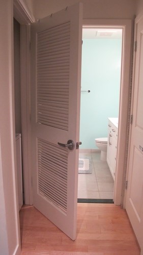 A white door is open to a bathroom.
