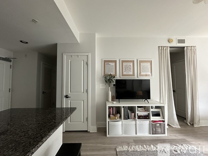 A white pantry with two doors, one open.