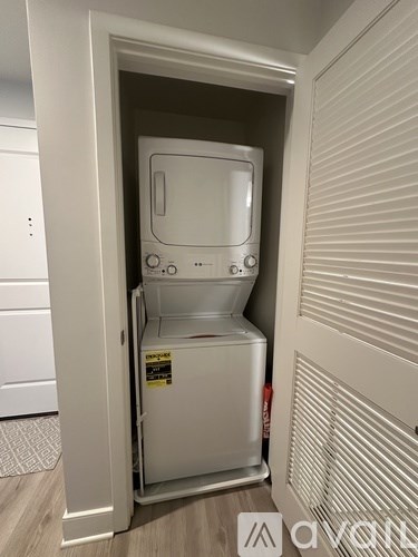 A white staircase with a light on the wall.