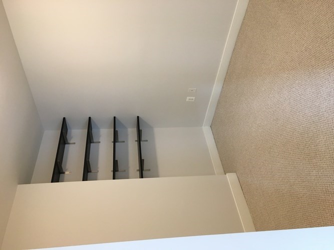 A staircase with a carpeted floor and white walls.