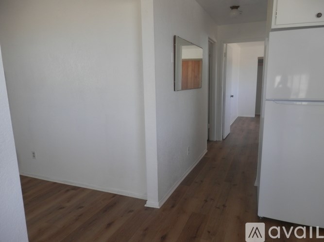 A room with wooden floors and white walls.