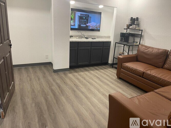 A living room with a brown couch and a television.