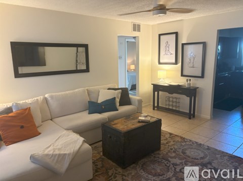 A living room with a white couch and a coffee table.