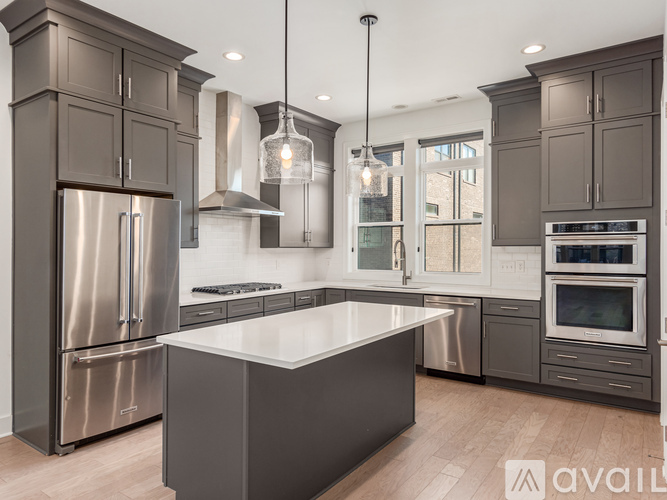 A modern kitchen with a large island in the center.