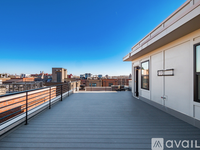 A balcony with a railing and a building in the background.