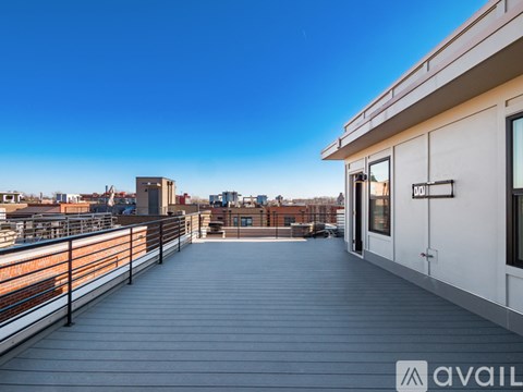 A balcony with a railing and a building in the background.