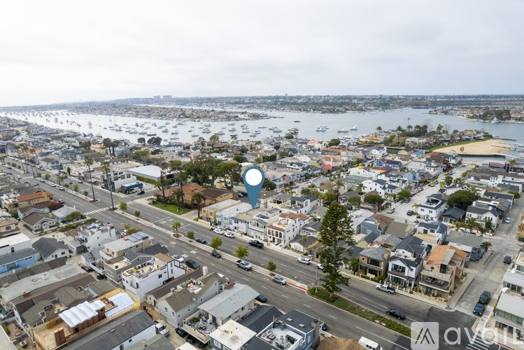 A bird's eye view of a coastal town with a road running through it.