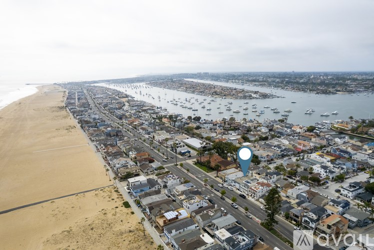 A beachfront town with a blue marker on a street.