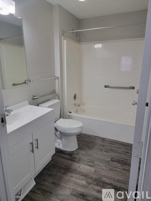 A bathroom with a toilet, sink, and shower.