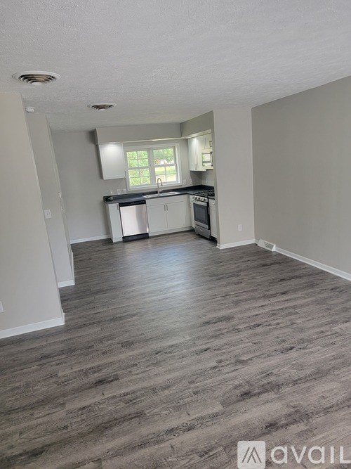 A kitchen area with a stove, oven, and cabinets.