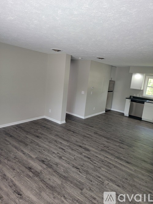 A room with grey flooring and white walls.