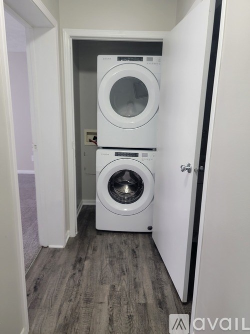 A laundry room with a washer and dryer stacked on top of each other.