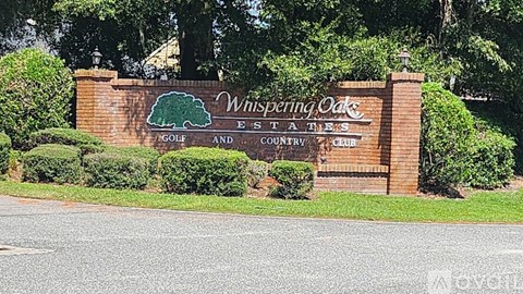 A sign for Whispering Oak Estates Golf and Country Club.