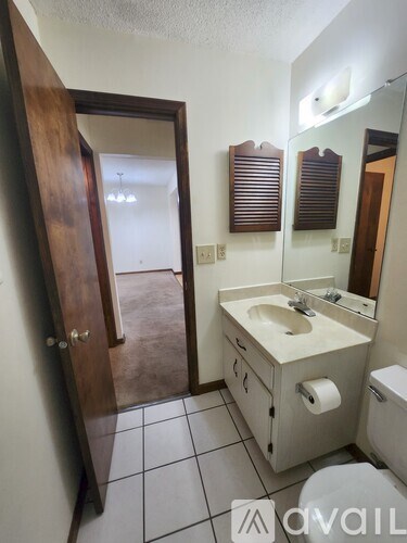 A bathroom with a toilet, sink, and shower.