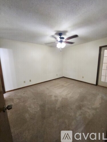 A room with a wooden wall and a sliding glass door.