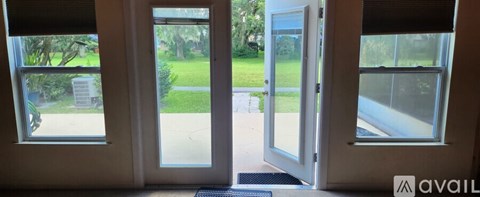 A white door with a glass window is open.