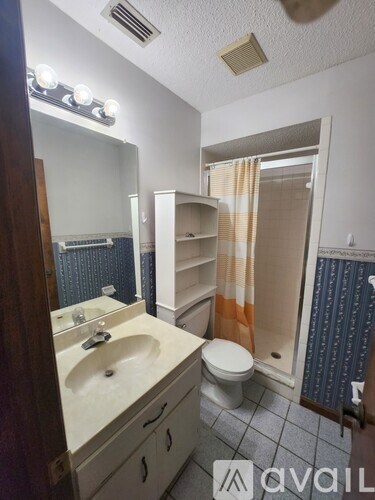 A room with a washer and dryer and a water heater.