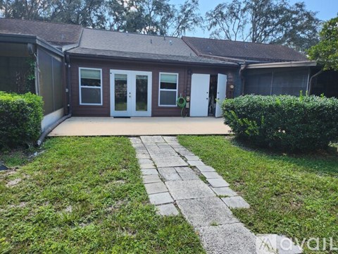 A house with a grey roof and a white door.