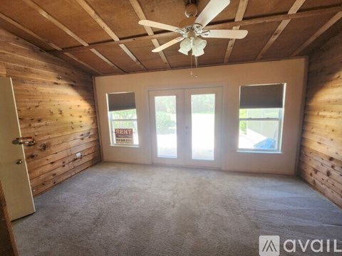 A garden with a stone pathway leading to a grassy area.