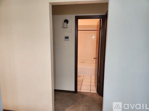 A bathroom with a toilet and a shower stall.