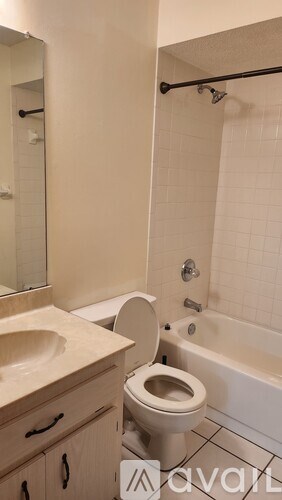 A bathroom with a toilet, sink, and bathtub.