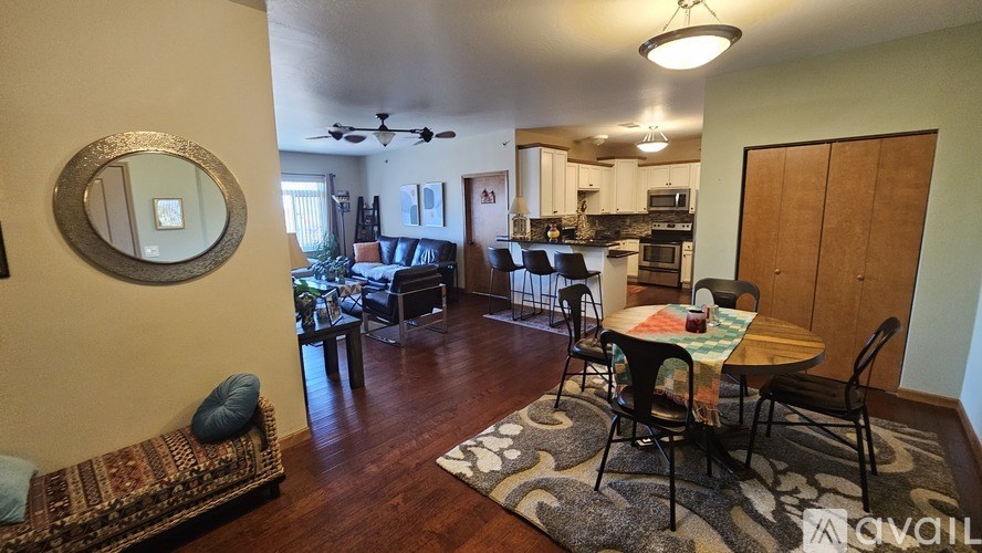 A living room with a round mirror on the wall.