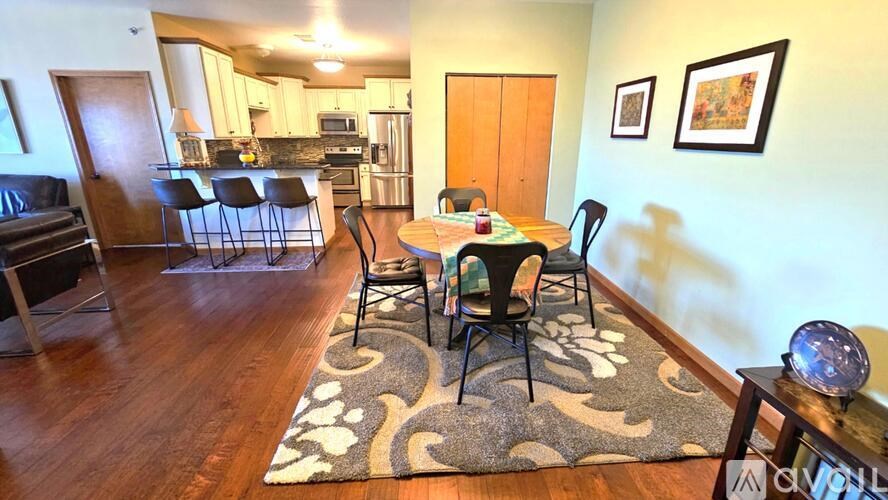 A dining room with a table set for four.
