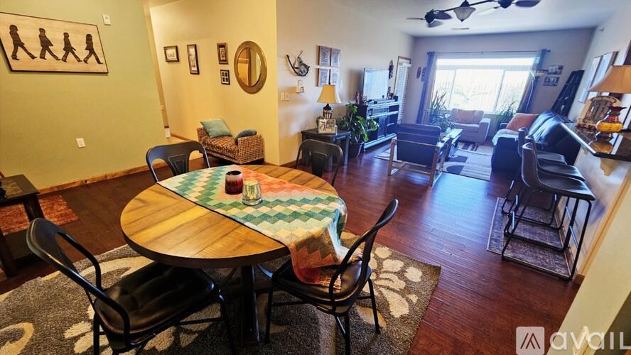A living room with a round table and chairs.