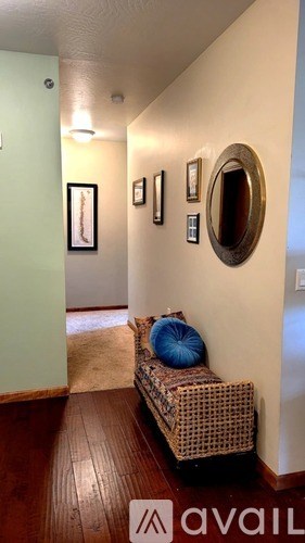 A hallway with a bench and pictures on the wall.