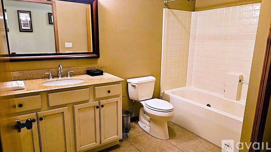 A bathroom with a sink, toilet, and bathtub.