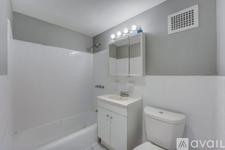 A bathroom with a white toilet and sink.