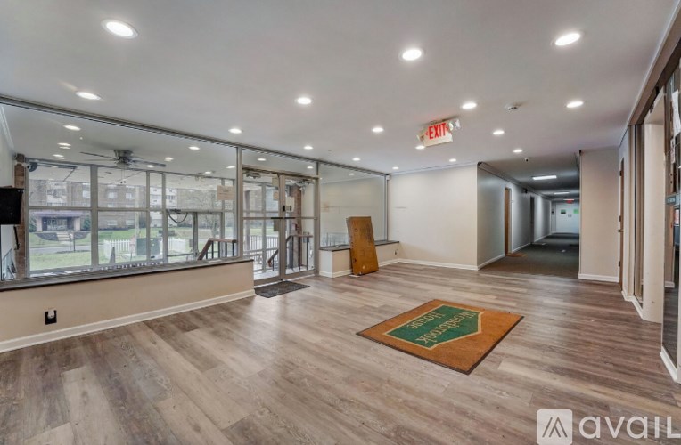A room with wooden floors and a green mat on the floor.