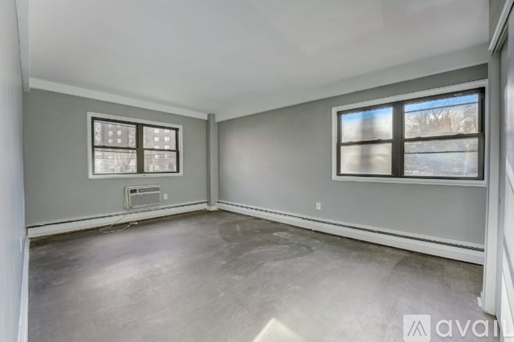 A room with a window and a wall-mounted air conditioner unit.