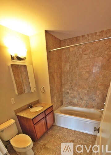 A bathroom with a toilet, sink, and bathtub.